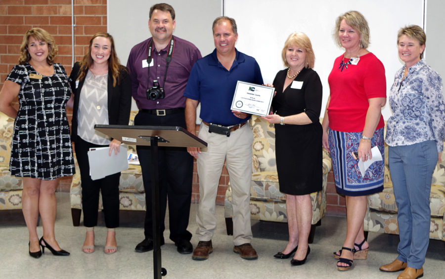 Tracy Hall (CVCC Education Matters), Meaghan Lewis (NC Chamber), Gary Herman (Alexander County EDC), Ryan Mayberry (Alexander County Commission Chairman), Linda Graham (CVCC Alexander Center for Education), Susan Gantt (Alexander County Schools), and Wendy Johnson (WPCOG) accept the Certified Work Ready Community certificate at the 9/30/16 ceremony.